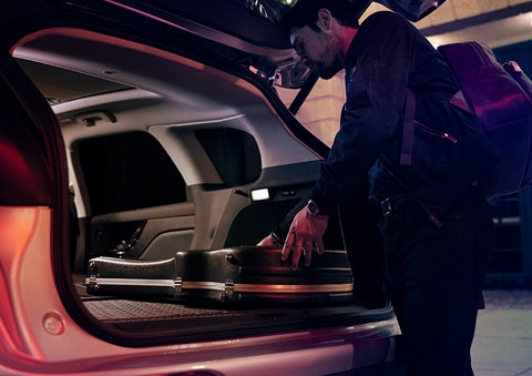 A man is shown loading cargo into the rear of a 2023 Lincoln Corsair® SUV with the second-row seats folded flat. | Cavalier Lincoln in Chesapeake VA