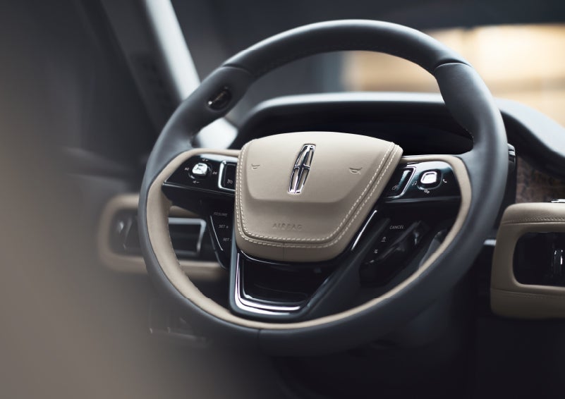 The intuitively placed controls of the steering wheel on a 2022 Lincoln® Aviator