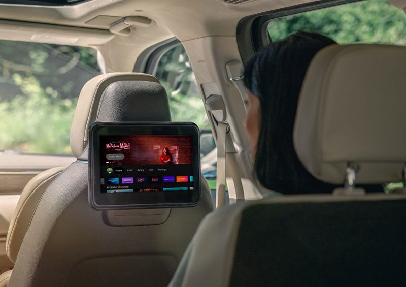 A person is seated in a 2023 Lincoln Nautilus SUV viewing an available entertainment screen. | Cavalier Lincoln in Chesapeake VA
