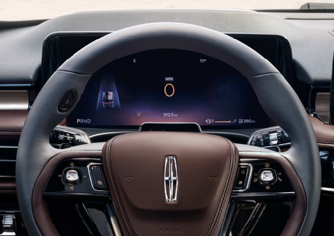 The steering wheel of 2025 Lincoln Aviator® SUV is shown with black and brown accents. | Cavalier Lincoln in Chesapeake VA