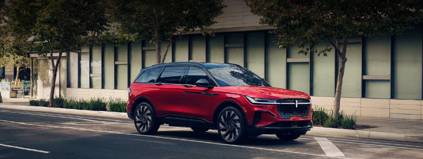 A 2025 Lincoln Nautilus® SUV with an available hybrid powertrain is parked in an urban setting. | Cavalier Lincoln in Chesapeake VA