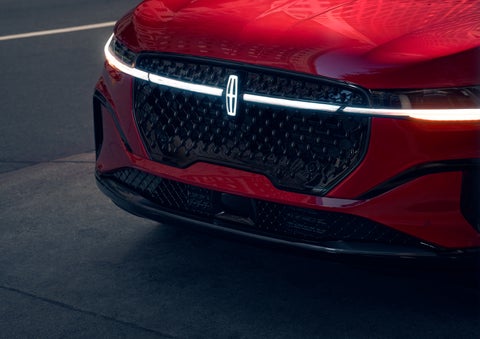 The available front LED light bar and center Lincoln Star logo glow at dusk. | Cavalier Lincoln in Chesapeake VA