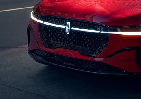 The available front LED light bar and center Lincoln Star logo glow at dusk. | Cavalier Lincoln in Chesapeake VA