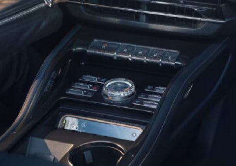 A smartphone is shown charging in the wireless charging pad. | Cavalier Lincoln in Chesapeake VA