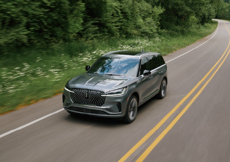 A 2027 Lincoln Aviator® SUV is being driven down a road. | Cavalier Lincoln in Chesapeake VA