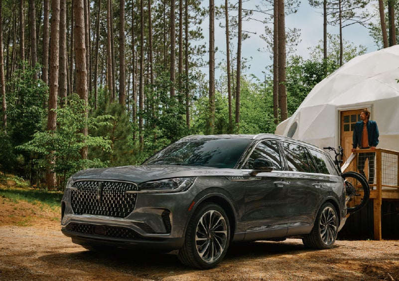 A 2027 Lincoln Aviator® is parked next to a high end glamping site. | Cavalier Lincoln in Chesapeake VA
