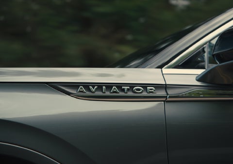 The driver’s side door and fender badging of a gray 2027 Lincoln Aviator® SUV are showcased. | Cavalier Lincoln in Chesapeake VA