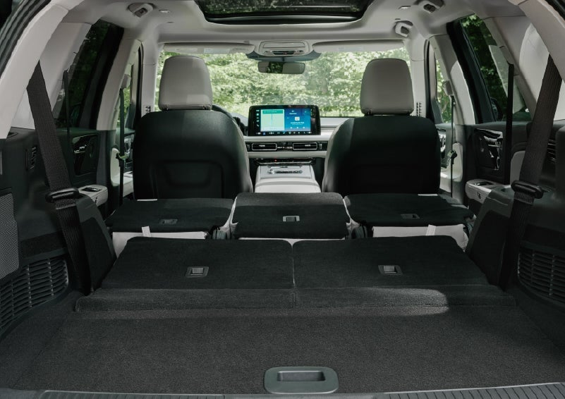 A rear to front view of the interior of a 2027 Lincoln Aviator® Black Label™ SUV shows the third and second rows folded flat | Cavalier Lincoln in Chesapeake VA