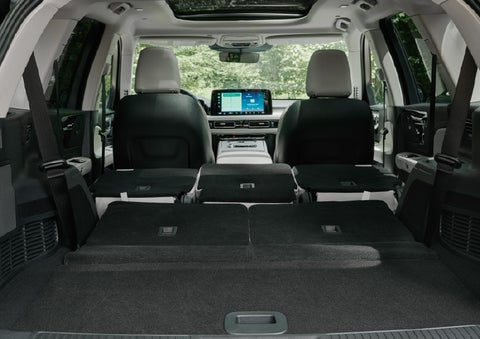 A rear to front view of the interior of a 2027 Lincoln Aviator® Black Label™ SUV shows the third and second rows folded flat | Cavalier Lincoln in Chesapeake VA