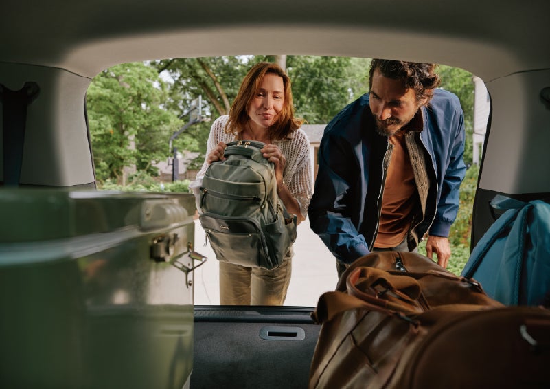 A couple loads luggage into the rear of a 2027 Lincoln Aviator® Black Label™ SUV..e 202 | Cavalier Lincoln in Chesapeake VA